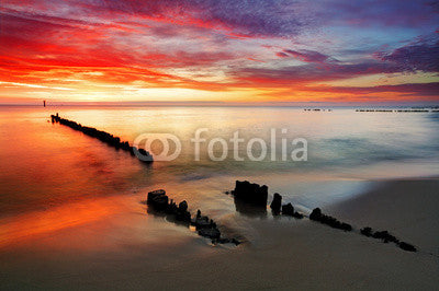 Poland, Ocean sunset on beach. Wall Mural