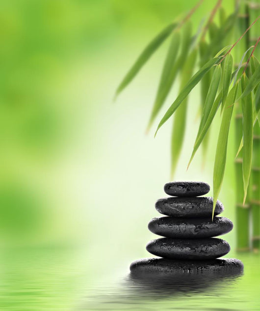 Tranquil zen design with stacked massage stones and bamboo Wall Mural