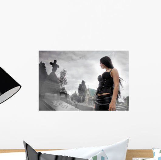 Long black haired woman in a misty cemetery Wall Mural