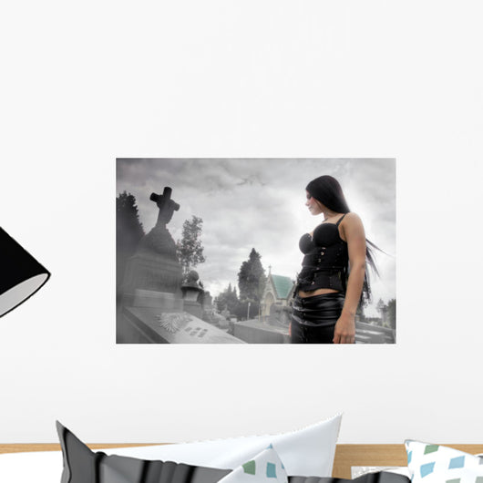 Long black haired woman in a misty cemetery Wall Mural