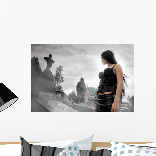 Long black haired woman in a misty cemetery Wall Mural