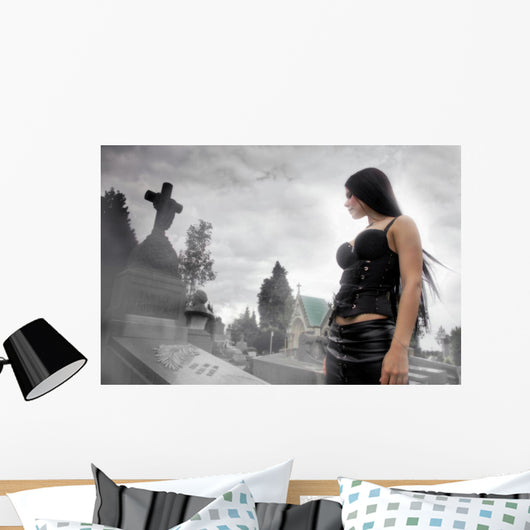 Long black haired woman in a misty cemetery Wall Mural