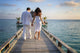 Sensual happy lovers in white clothes on the beach (Maldives) Wall Mural