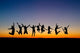 Silhouette Friends Jumping Sunset