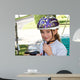 Cute Girl in a Helmet Is Going for a Ride Wall Mural