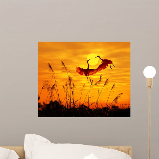 bulrushes against sunlight in sunset with a flighting birds Wall Mural