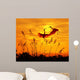 bulrushes against sunlight in sunset with a flighting birds Wall Mural