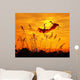 bulrushes against sunlight in sunset with a flighting birds Wall Mural