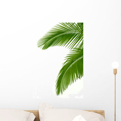 Two Palm Tree Leaves Wall Decal shown on a wall