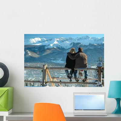 Couple Sitting on Fence at Tatra Mountains Wall Decal shown on a wall
