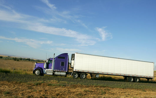 Semi truck going fast on interstate highway Wall Mural