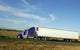Semi truck going fast on interstate highway Wall Mural