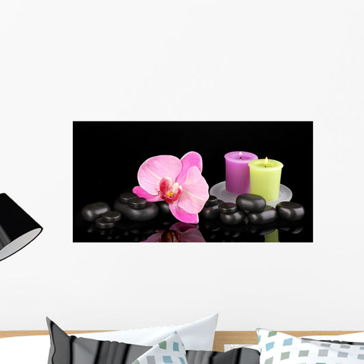 Spa stones with orchid flower and candles isolated on black Wall Mural