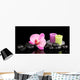 Spa stones with orchid flower and candles isolated on black Wall Mural
