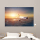 Airplane in the sky at sunset Wall Mural