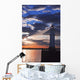 Lighthouse at sunset with light beam Wall Mural