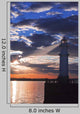 Lighthouse at sunset with light beam Wall Mural