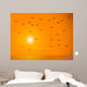 Flying Birds Against Orange Sunset Wall Mural