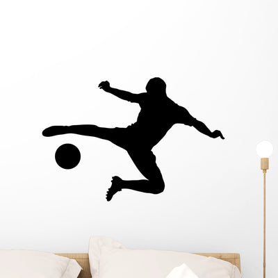Silhouette Soccer Player Shooting Wall Mural shown on a wall