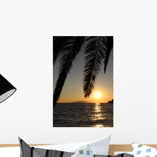 Palm leafs and sea in the evening, sunset Wall Mural