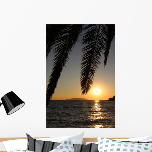 Palm leafs and sea in the evening, sunset Wall Mural