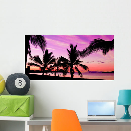 Palms silhouettes at sunset on a tropical beach Wall Mural