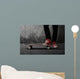 Legs in sneakers on a skateboard Wall Mural