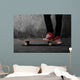 Legs in sneakers on a skateboard Wall Mural