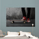 Legs in sneakers on a skateboard Wall Mural