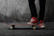 Legs in sneakers on a skateboard Wall Mural