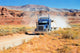 Semi-truck driving across the desert Wall Mural