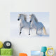 Two galloping snow-white horses 