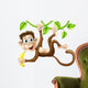 Monkey swinging with banana Wall Decal
