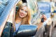 Young Woman Showing Car