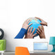Teamwok concept with hands on globe Wall Decal