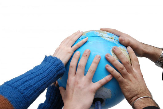 Teamwok concept with hands on globe Wall Decal