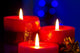 Christmas candles with blurry lights on background Wall Mural