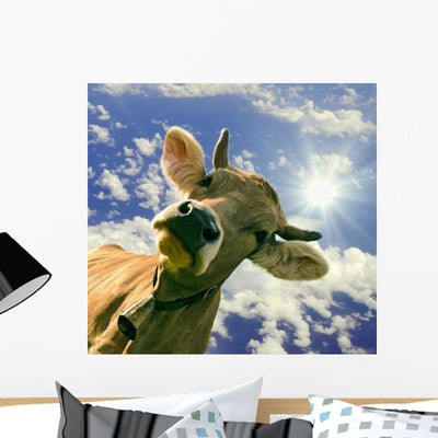 Happy Brown Cow against shown on a wall