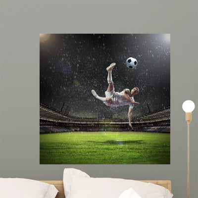 Football Player Striking Ball shown on a wall