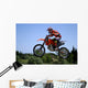 red and orange moto x or motor cross bike giving big air on dirt Wall Mural