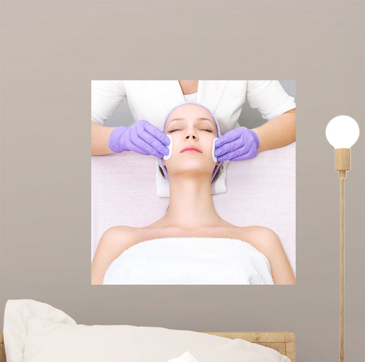 Young woman receiving beauty therapy Wall Mural