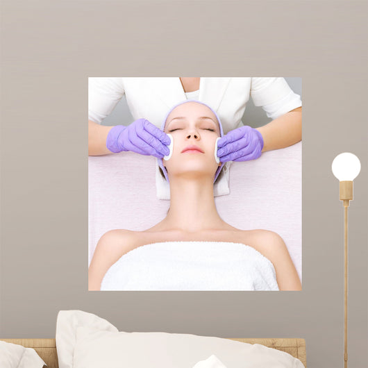 Young woman receiving beauty therapy Wall Mural