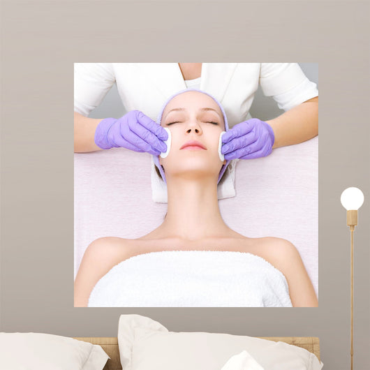 Young woman receiving beauty therapy Wall Mural