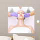 Young woman receiving beauty therapy Wall Mural