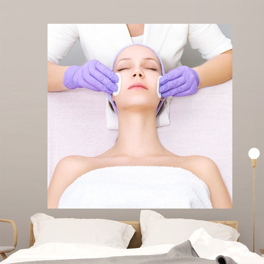 Young woman receiving beauty therapy Wall Mural