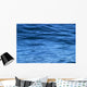 beautiful calm ripples on deep blue ocean on a bright sunny day Wall Mural