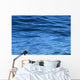 beautiful calm ripples on deep blue ocean on a bright sunny day Wall Mural
