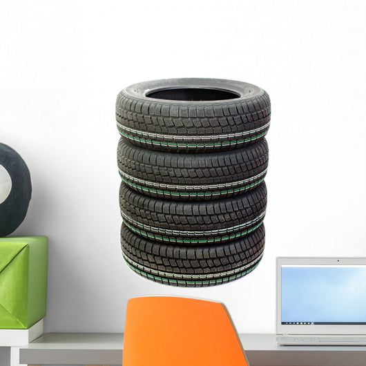 Four new tires stacked on white background Wall Decal