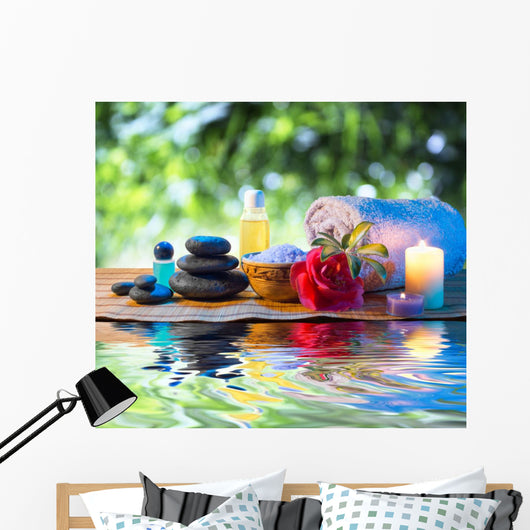 stones, candle camellia oil salt towel on water Wall Mural