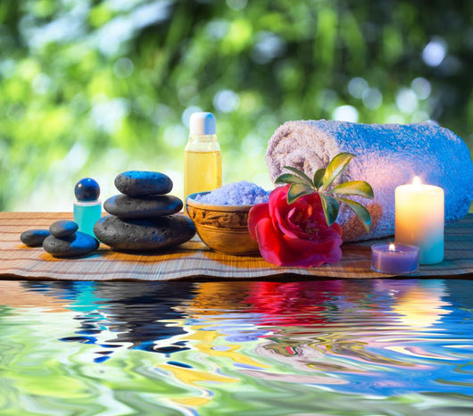 stones, candle camellia oil salt towel on water Wall Mural